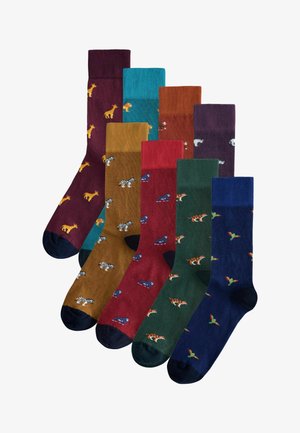 Acht Paar Socken in verschiedenen Farben, darunter Burgunder, Grün und Blau, mit verspielten Tiermustern und gerippten Bündchen.
