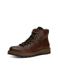 Stivale da hiking in pelle marrone con suola robusta, occhielli in metallo e lacci verdi, dotato di una cavigliera imbottita per supporto e durabilità.