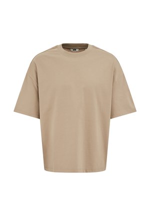 Beige värinen, ylikokoinen lyhythihainen puuvillainen T-paita, jossa on pyöreä kaula-aukko ja pudotetut olkapäät, esillä valkoisella taustalla.