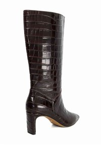 Brown crocodile-embossed leather knee-high boot with a pointed toe, slim heel, and vertical pattern, showcasing a glossy texture.