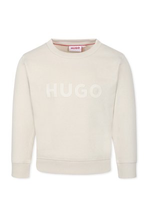 Sweatshirt beige à col rond avec un logo "HUGO" texturé sur le devant, des poignets et un ourlet côtelés, fabriqué à partir d'un matériau doux.