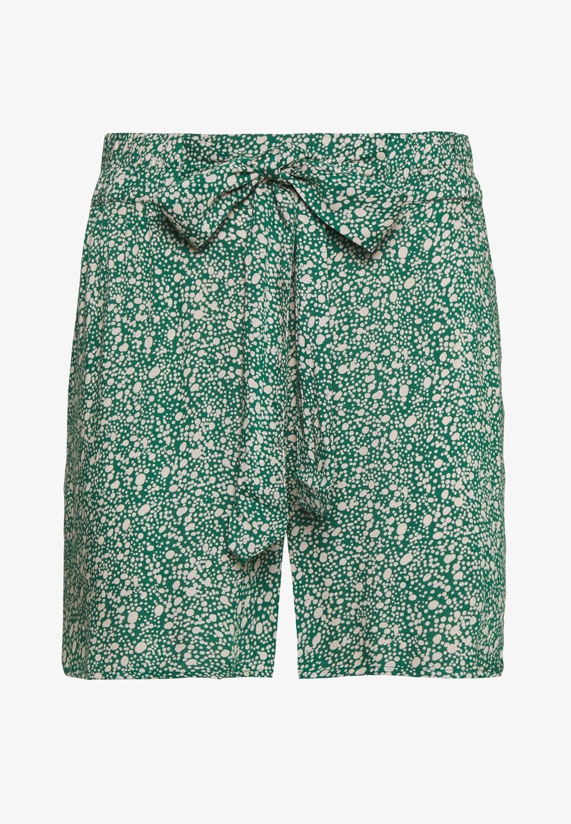 Short vert avec des taches blanches abstraites, taille haute et ceinture en tissu nouée en nœud à l'avant.