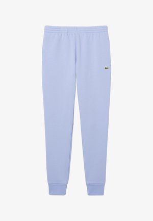 Pantalons de survêtement bleu clair avec taille élastique et chevilles élastiques, arborant un petit logo crocodile vert sur la cuisse droite.