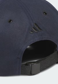 Navy baseball cap with a structured design, fabric texture, black accents, and adjustable strap with a metal clasp at the back.