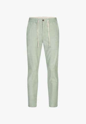 Ljust gröna joggerbyxor med resår i midjan, vita snören och en framknapp. Tillverkade av ett mjukt, texturerat tyg.