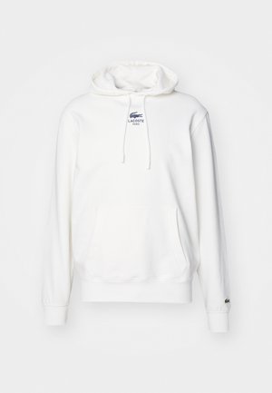 White fleece hoodie featuring a kangaroo pocket, drawstring hood, and a small blue embroidered Lacoste logo on the chest.
