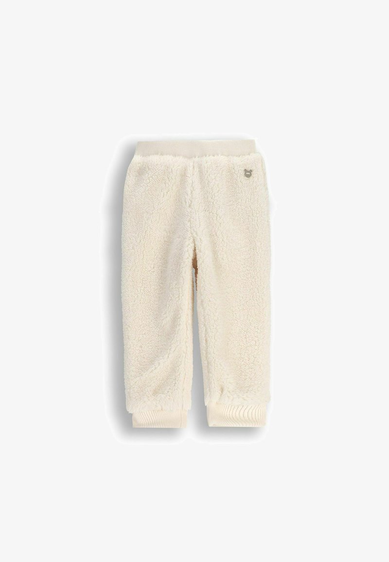 Joggery z dzianiny w kolorze kremowym, wykonane z miękkiego, teksturowanego materiału, z prążkowanym paskiem w talii i mankietami oraz małym akcentem z logo.