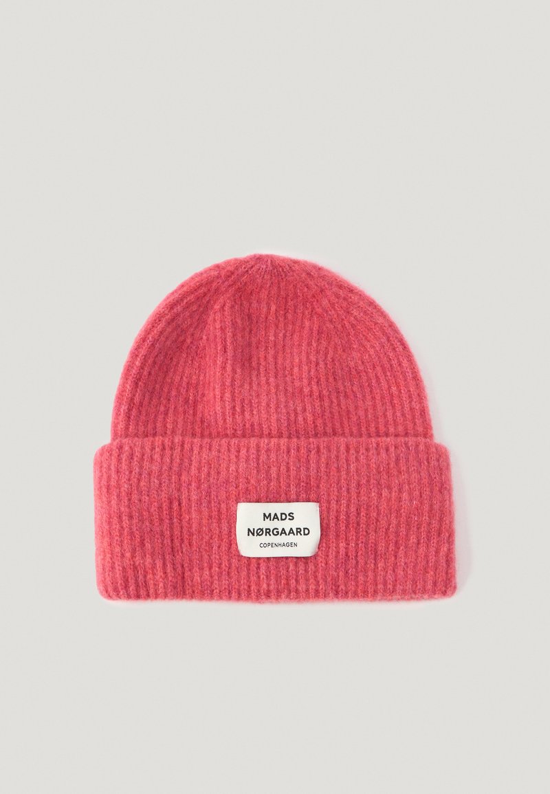 Pink knit beanie with a ribbed texture and a folded cuff. Features a white label with black text: "MADS NØRGAARD COPENHAGEN."