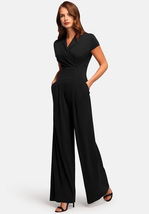 Black jumpsuit with a wrap bodice, short sleeves, wide legs, and side pockets. Made from smooth fabric with a fitted waist.