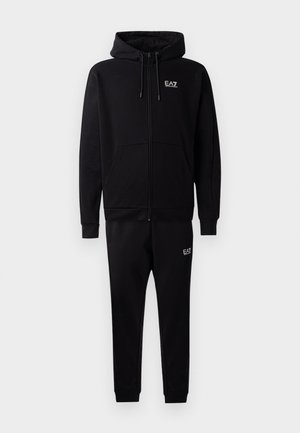 Black zip-up hoodie with drawstrings and side pockets, paired with matching black sweatpants featuring leg cuffs and a small logo accent.