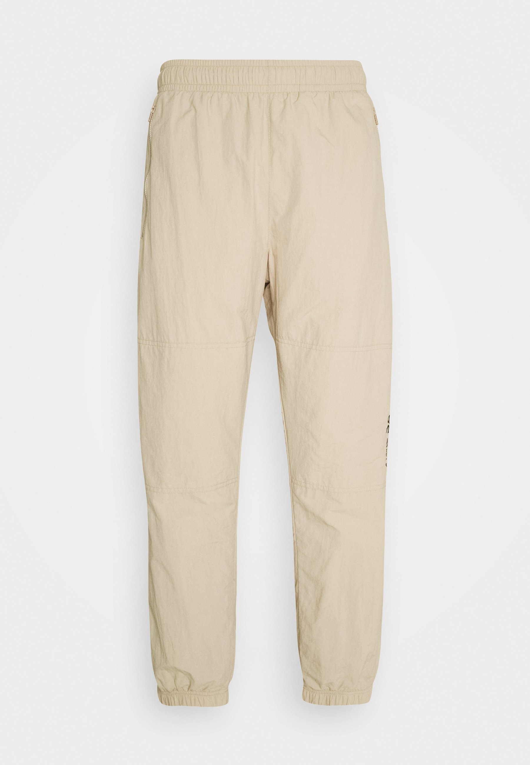nike track pants beige
