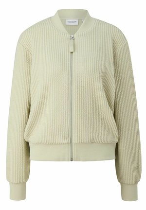 Veste bomber en maille beige clair texturée avec col, poignets, ourlet côtelés et fermeture éclair frontale.