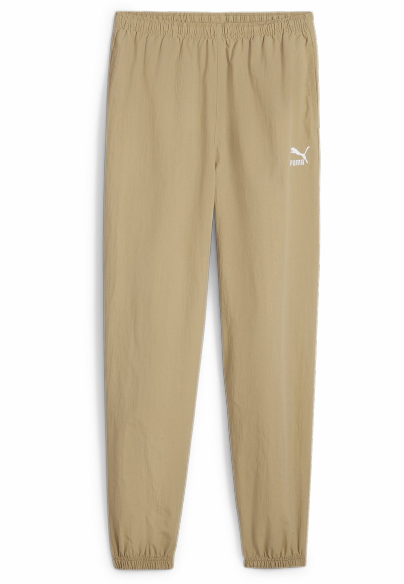 Beige sweatpants met een elastische tailleband, opgesmukte enkels en een wit Puma-logo op het linkerbeen. Lichtgewicht, gladde stof.