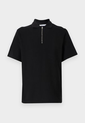 Black short-sleeve polo shirt made of soft fabric, featuring a zippered collar and a clean, minimalistic design without additional patterns.