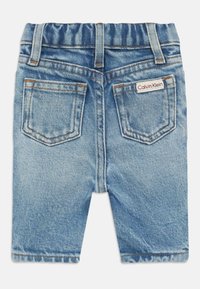 Lyseblå barne denimshorts med elastisk midje, to baklommer og en liten Calvin Klein-merkelapp på høyre lomme.