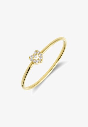Delicate gold ring with a small heart-shaped centerpiece made of round, sparkling diamonds against a white background.