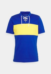 Modrá a žlutá polokošile s krátkým rukávem, s šněrováním u výstřihu a designem s bloky barev. Vyrobeno z bavlněné směsi pro pohodlí.