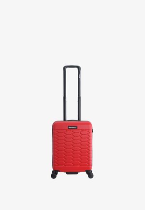 Red hardshell carry-on suitcase with a textured honeycomb pattern, retractable black handle, and four wheels for mobility.
