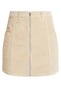 Gonna mini in velluto a coste beige con due tasche frontali e chiusura centrale con zip. Tessuto testurizzato con costine verticali.