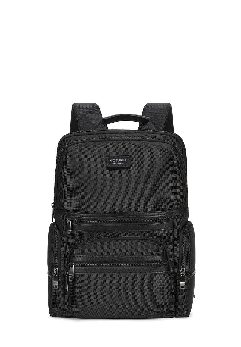 Sac à dos noir en tissu texturé, doté de plusieurs compartiments zippés, de bretelles rembourrées et d'une poignée supérieure pour un transport facile.