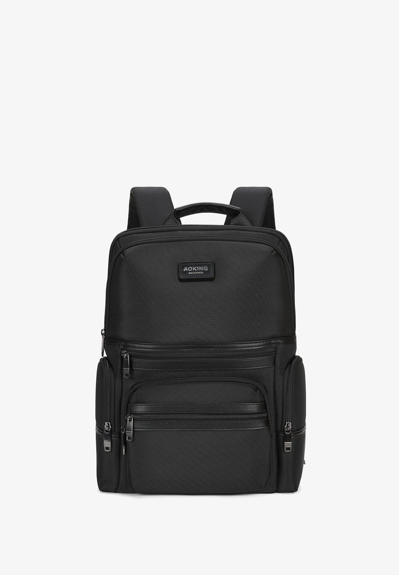 Zaino nero in tessuto testurizzato, dotato di più scomparti con zip, spallacci imbottiti e una maniglia superiore per la portabilità.