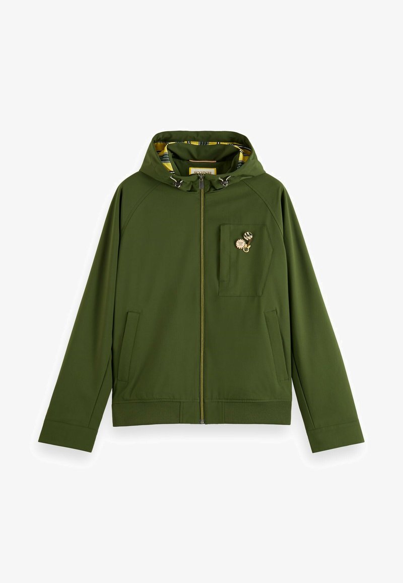 Zeleno kapuco jakno s celotnim sprednjim zadrgo, dvema stranskima žepoma, žepom na prsih in rumenim vzorčastim notranjim oblogom. Vsebuje kovinske dodatke.