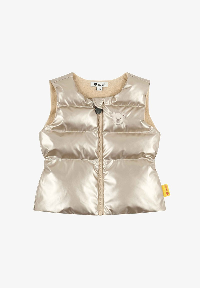 Chaleco acolchado beige con un acabado brillante y logo de oso. Presenta una cremallera frontal, diseño sin mangas y forro suave. Fabricado con materiales sintéticos.