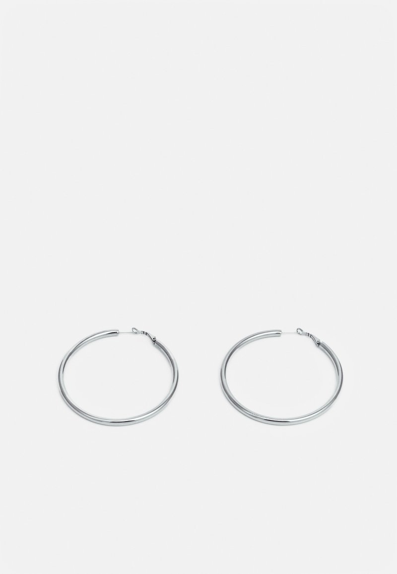 Paire de boucles d'oreilles créoles en argent de taille moyenne avec fermoirs à charnière sur fond blanc uni.
