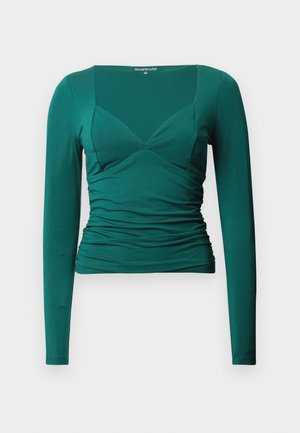 Green long-sleeve top made of soft material; features a V-neck, ruched sides, and a fitted shape. Smooth texture, minimalistic design.