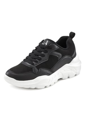Black sneaker with a textured leather and suede upper, featuring a white chunky sole, black laces, and a small logo on the tongue.