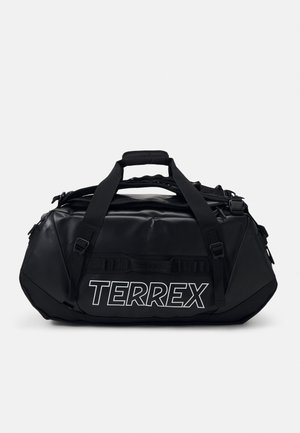 Sort duffel taske lavet af slidstærkt materiale, med et fremtrædende hvidt "TERREX"-logo, forskellige stropper og et slankt, afrundet design.