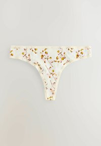Tanga con stampa floreale realizzata in tessuto morbido, con uno sfondo cremoso decorato da fiori rosa e gialli, e un delicato bordo in pizzo.