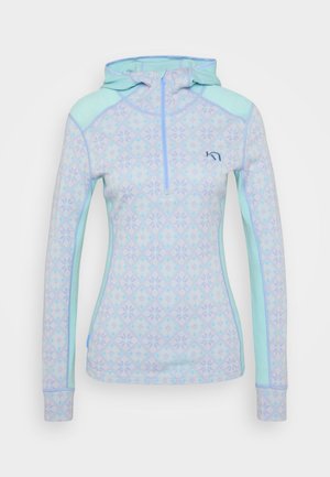 Light blue top with a patterned design featuring geometric shapes. Includes a hood and half zip. Fabric appears soft with contrasting accents.