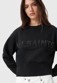 Felpa corta nera con la scritta 'ALLSAINTS' in accenti di perline nere lucide, scollatura a girocollo e polsini a costine per un tocco di texture.