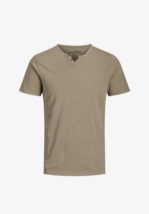 Short-sleeve, crew neck t-shirt in light brown with a textured finish and two button accents at the neckline.