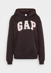 Hanorac negru cu un mare logo brodat „GAP” în roz pe partea din față, buzunar tip cangur, glug�ă cu șnur și manșete ribbed.