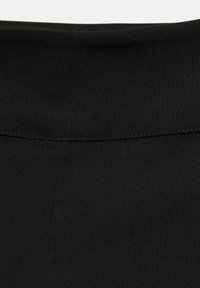 Gros plan d'une ceinture en tissu noir taille haute avec des coutures visibles et une texture lisse.