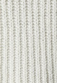 Chunky knit fabric in soft white, featuring a textured pattern of vertical ribs and interlocking stitches.