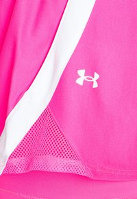 Bright pink athletic top featuring smooth fabric with white mesh accents. Includes a small white logo on the front, showcasing a layered design.