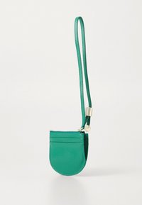 Green leather mini bag with a rounded shape, zipper closure, credit card slots, and a slim adjustable strap. Gold-tone hardware accents.