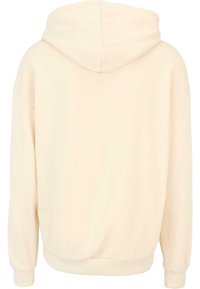 Cream-colored hoodie with a soft texture, a large hood, dropped shoulders, and ribbed cuffs and hem. Simple, minimal design without graphics.