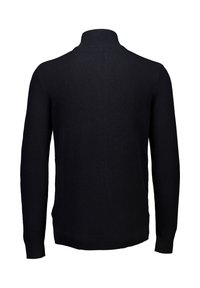 Svart stickad tröja med hög krage, långa ärmar och ett strukturerat mönster. Har ribbade muddar och fåll, utan synliga knäppningar.