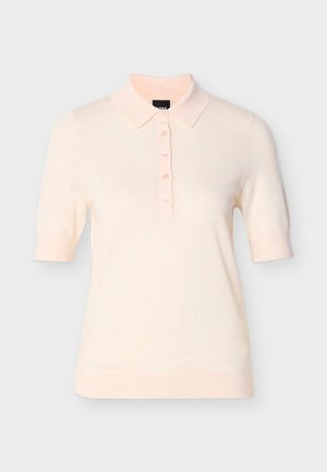 Világos rózsaszín rövid ujjú polo ing klasszikus gallérral, öt gombos elejével és finom kötött textúrával. Egyszerű és minimalista kialakítás.
