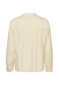 Crème-kleurig shirt, gemaakt van gestructureerde stof, met een kraag, lange mouwen en knoopdetails bij de manchetten.