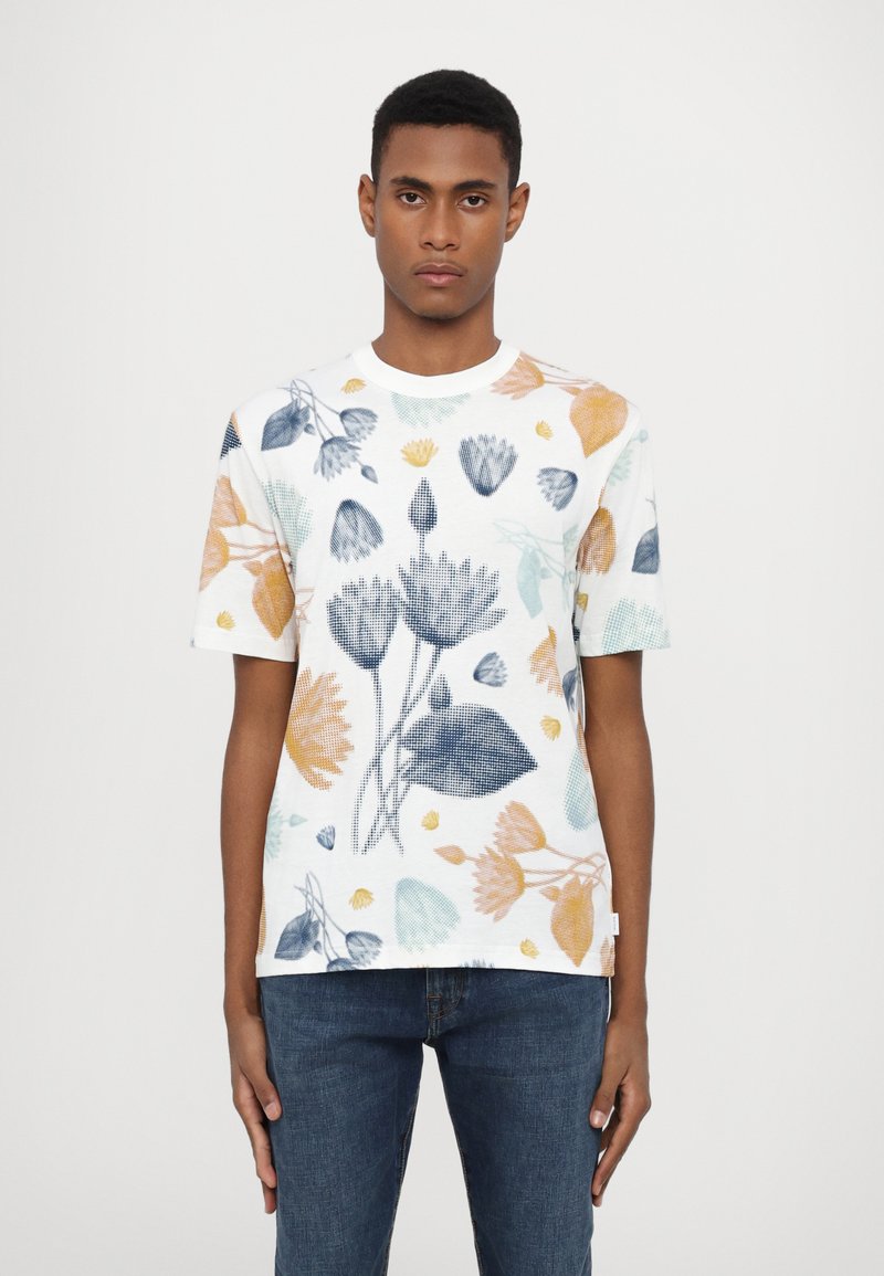Short-sleeve white t-shirt featuring a floral print in blue, orange, and green tones. Fabric has a textured, breathable appearance.