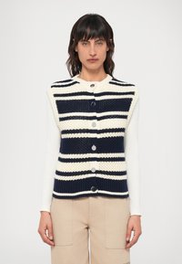 Colete tricotado com riscas azuis e brancas, com decote redondo e botões prateados. Feito de fio texturizado, com mangas curtas.