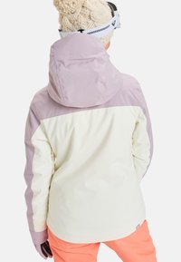 Ski jacket with a fitted hood, pastel purple and cream color blocks, a smooth, waterproof texture, featuring elastic cuffs and a side zipper.