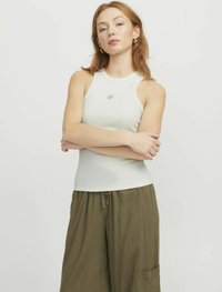 Lys grøn ribbet tanktop med rund halsudskæring og et lille emblem på brystet, parret med løse olivengrønne wide-leg bukser.