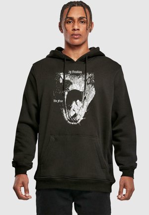 Black hoodie featuring a graphic print of a wolf's mouth and "No Fear" text. It has a front pocket and drawstrings at the hood.
