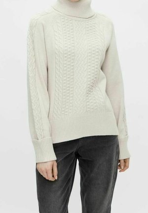 Maglione corto beige chiaro a maglia, con colletto alto, caratterizzato da motivi testurizzati sulla parte anteriore e sulle maniche, e orlo e polsini a coste.